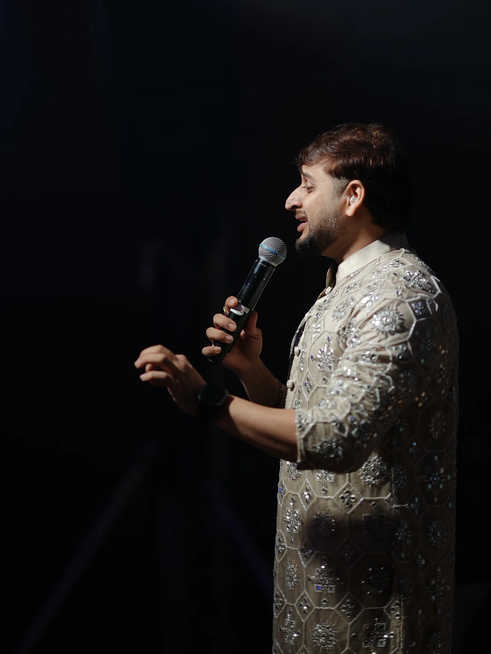 RSJ vocalist singing into a handheld microphone